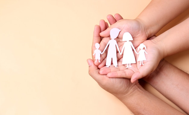 Photo hands holding paper family cutout