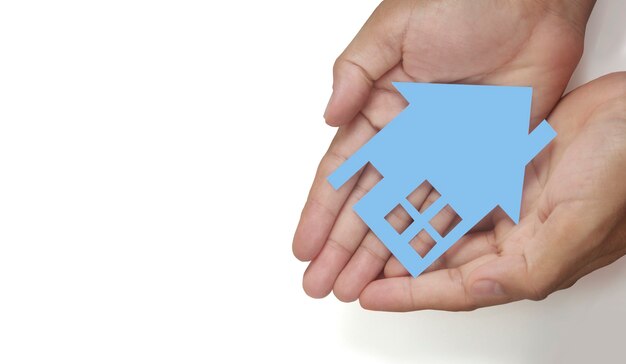 Hands holding paper house, family home and protecting insurance concept