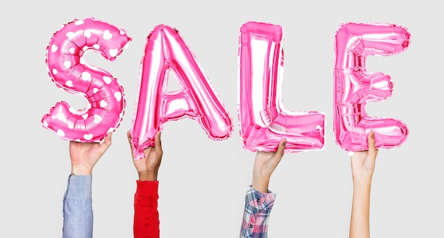 Hands holding sale word in balloon letters