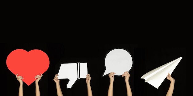 Hands holding the signs of social media on black studio background flyer