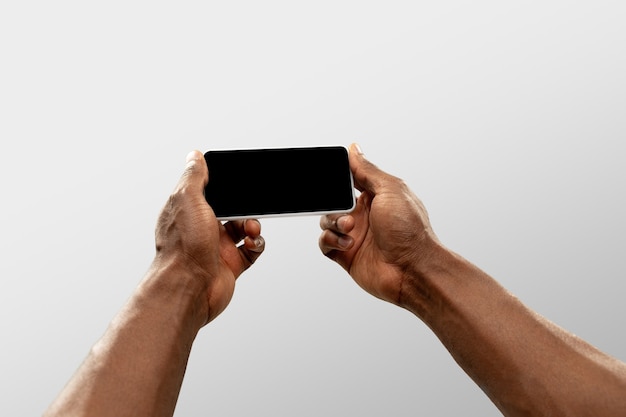 Hands holding smartphone, Copyspace for ad. White background