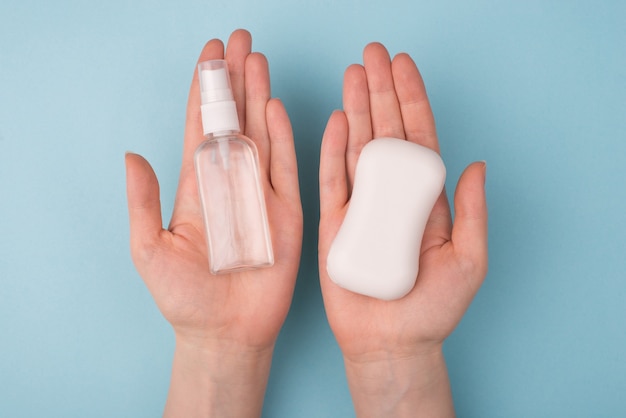 Hands holding soap and transparent antiseptic