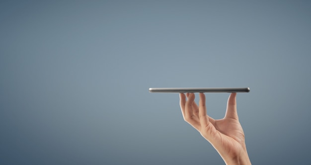 Hands holding a tablet touch computer gadget with isolated screen