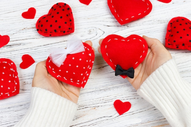 hands holding textile hearts