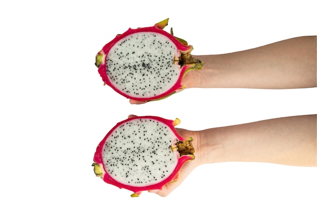 Hands holding two isolated halves of red dragon fruit or pitaya