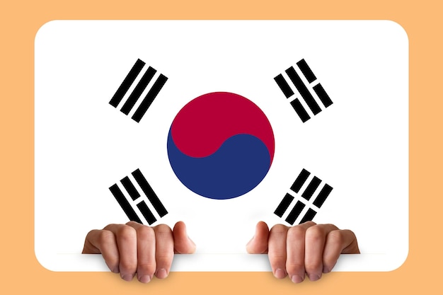 Hands holding a white frame with South Korea flag protest or social issues in South Korea