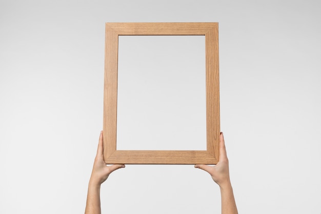 Hands holding wooden frame