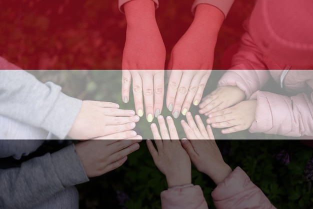 Hands of kids on background of Yemen flag Yemeni patriotism and unity concept