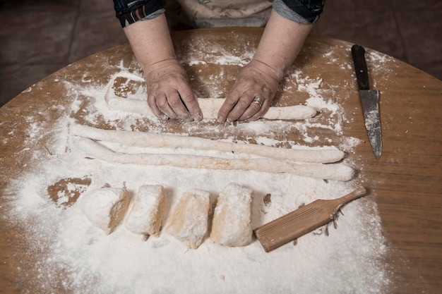 Hands kneading dough for gnocchi