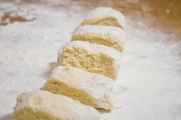 Hands kneading dough for gnocchi