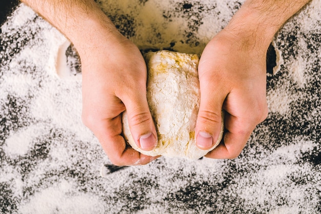 Hands kneading a dough