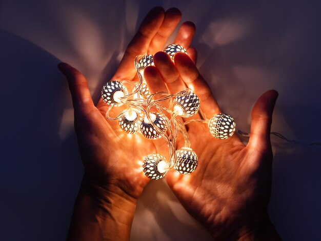 Hands  light bulbs. Metal light bulbs