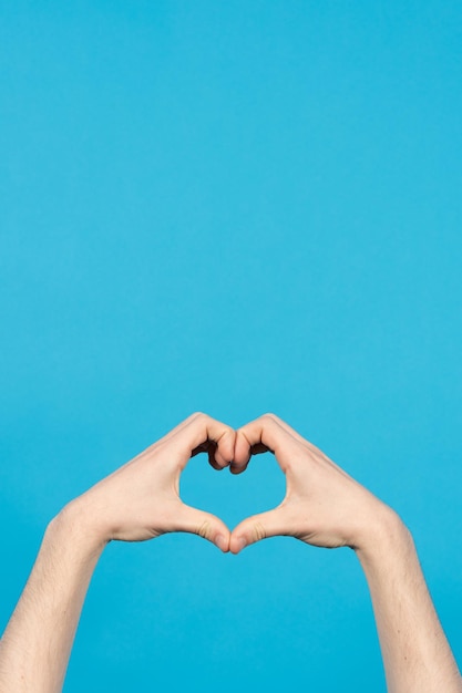 Hands making heart or love sign with copy space