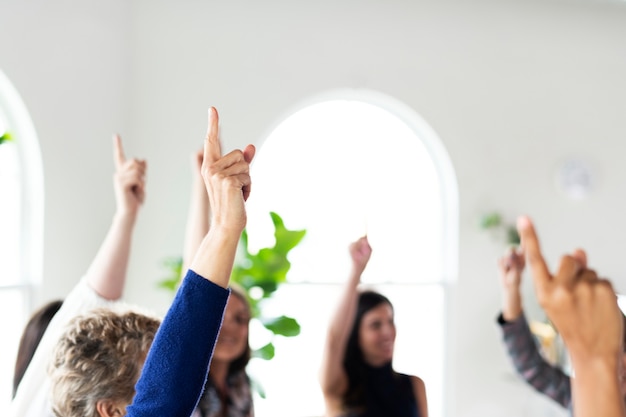 Hands making number one sign raised in the air