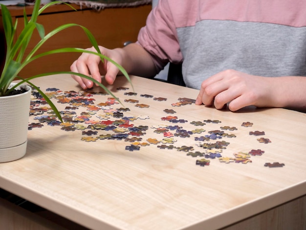 The hands of the man collecting puzzles The concept of recreation hobbies mental health