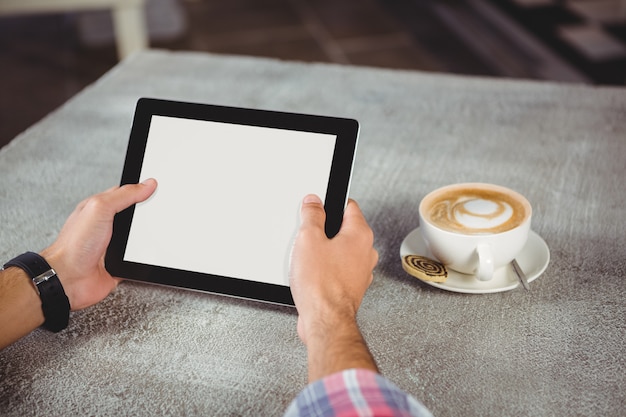 Hands of man holding digital tablet