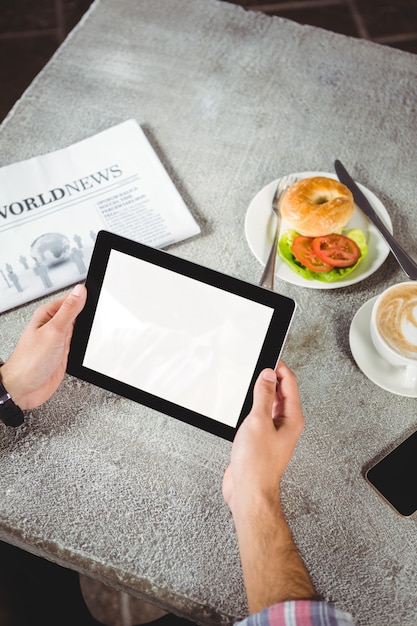 Hands of man holding digital tablet