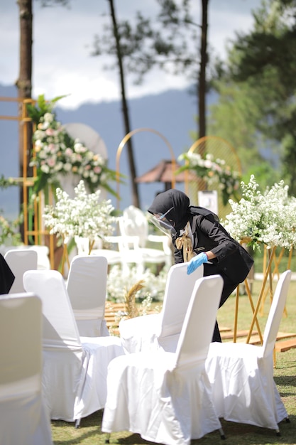 The hands of a man wearing blue gloves preparing for an event