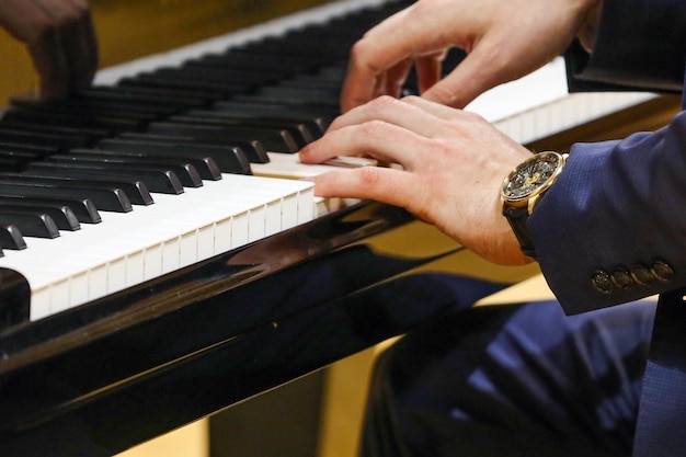 the hands of a man who plays the piano