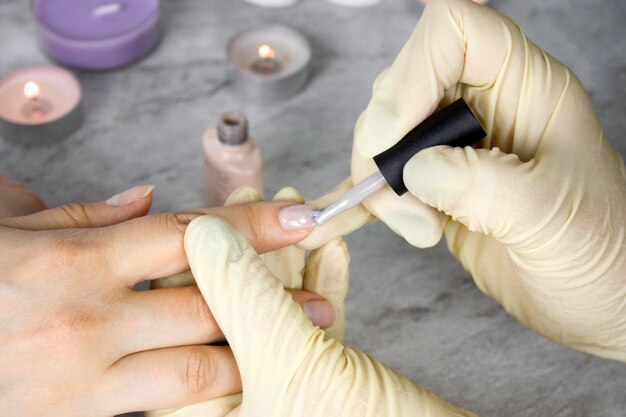 hands manicurist in gloves  holding hands of client