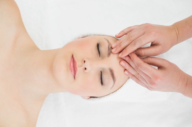 Hands massaging a beautiful womans forehead