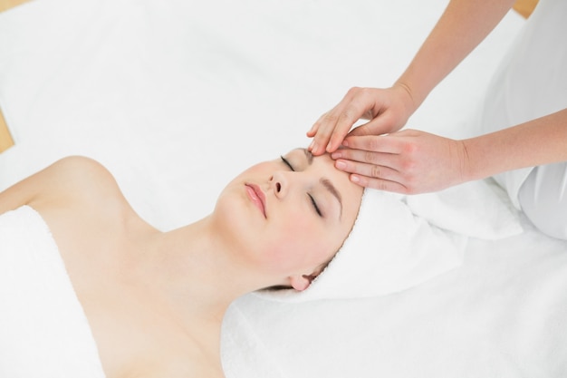 Hands massaging a beautiful womans forehead