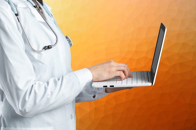 Hands of medical doctor woman with laptop