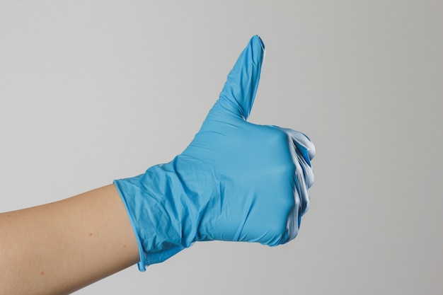 Hands in medical latex gloves. Hands form a heart shape.