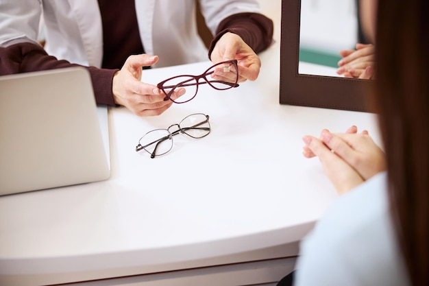 Hands of a medical person keeping the glasses