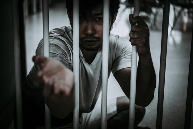 Hands of men desperate to catch the iron prisonprisoner conceptthailand peopleHope to be free