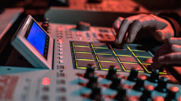 The hands of a musician creating on his drum machine