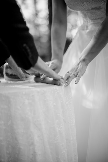 hands of the newlyweds closeup candle black and white photo