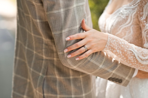 The hands of the newlyweds gently touch each other 3858