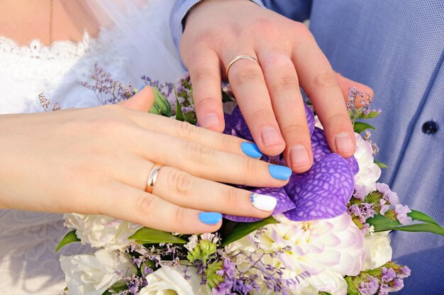 Hands of the newlyweds on the wedding bouquet Wedding Bridal bouquet