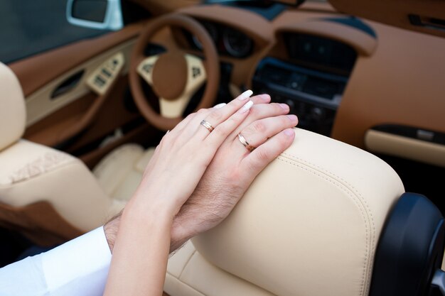 Hands newlyweds with wedding rings close up