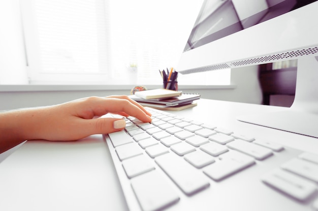 Hands of an office woman typing