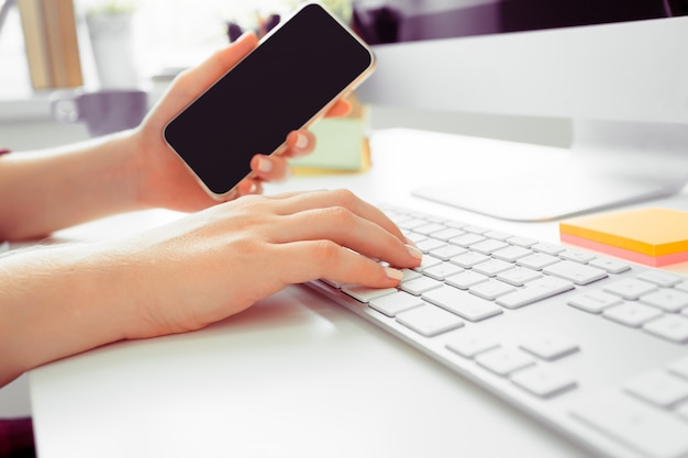 Hands of an office woman typing