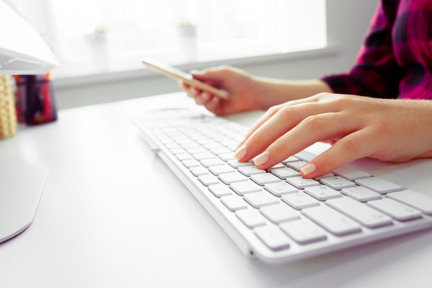 Hands of an office woman typing