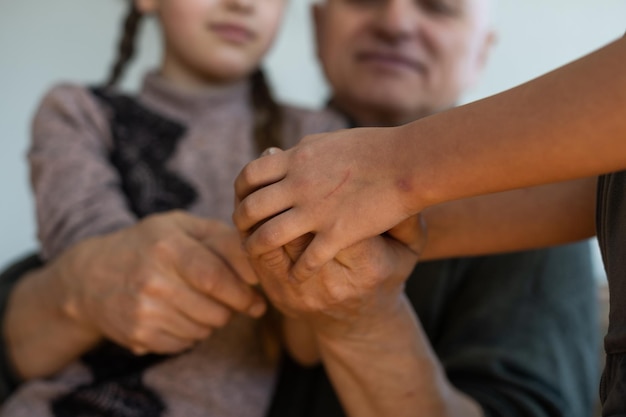 Photo hands of the old man and a child's hand.