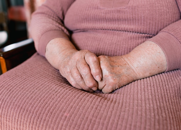 Hands of an old woman with wrinkles and age spots close-up. retired woman