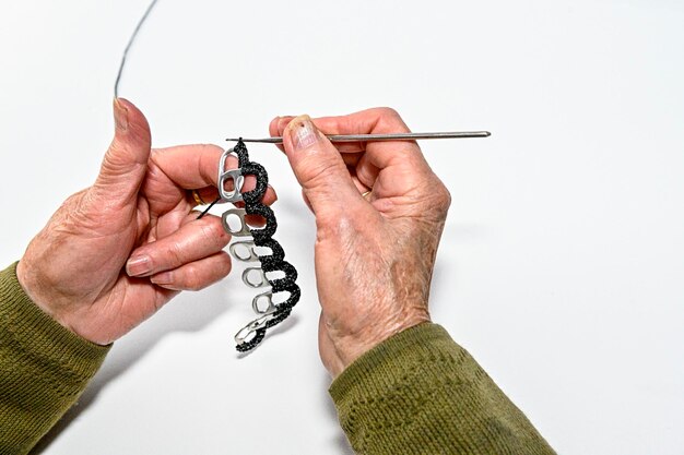 Hands of an older woman working on crafts