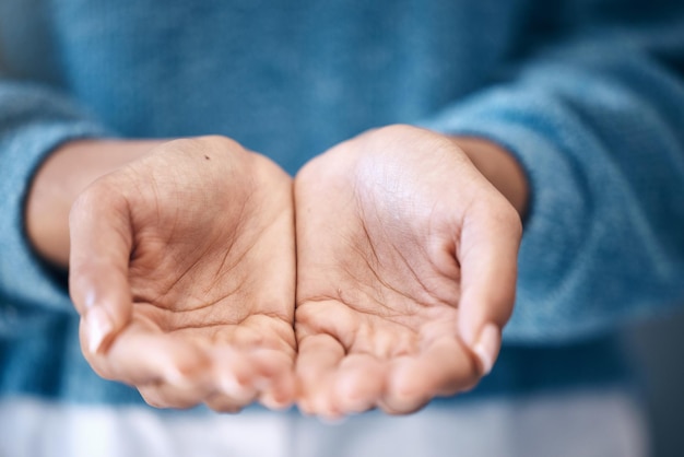 Hands open charity and support with a woman begging for help in studio closeup for humanity to share Community poverty and donation with female palms asking for aid compassion or kindness