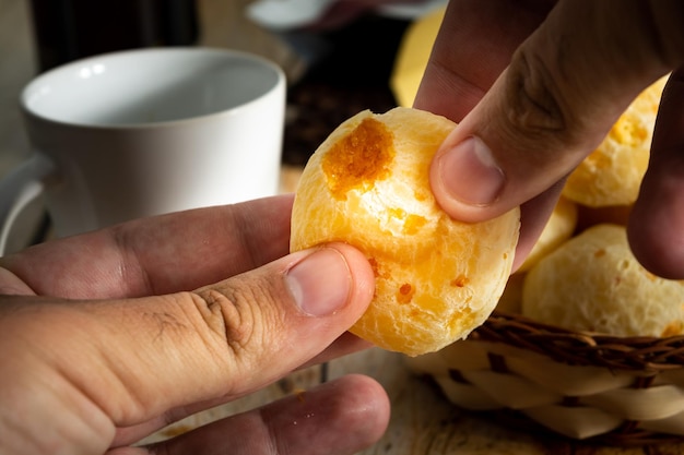 Hands opening a cheese bread in half