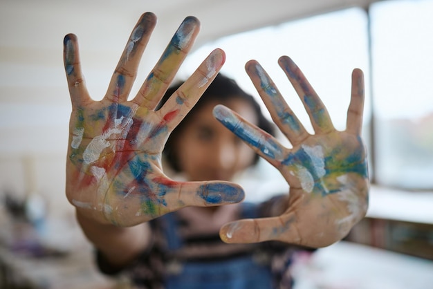 Hands paint and art with a woman creative artist or painter having fun in her studio or design workshop Palm color and artistic with a female working in a classroom or gallery for creativity