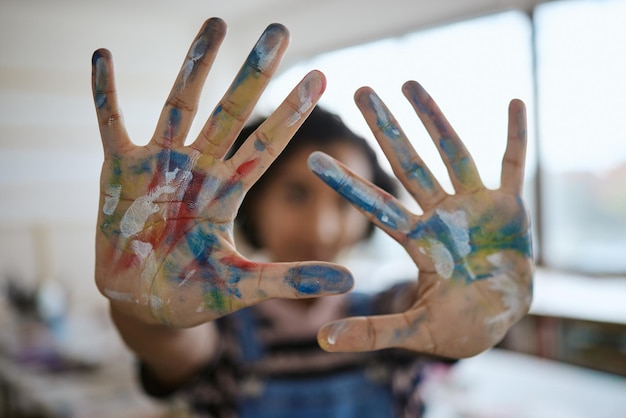 Foto le mani dipingono e fanno arte con un'artista creativa o una pittrice che si diverte nel suo studio o laboratorio di design colore del palmo e artistico con una donna che lavora in una classe o in una galleria per la creatività