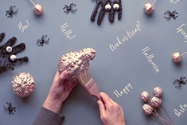 Hands painting decorative pumpkins