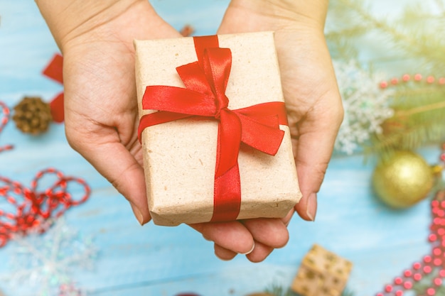 Hands, palms holding gift box close up