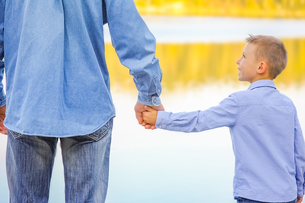 A Hands of parent and child in nature in the park travel