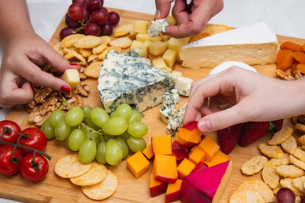 Foto mani di persone che raccolgono formaggio dal pesto