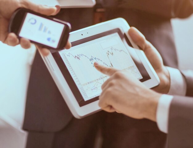 Hands of people working with tablet computer in office. Technology.